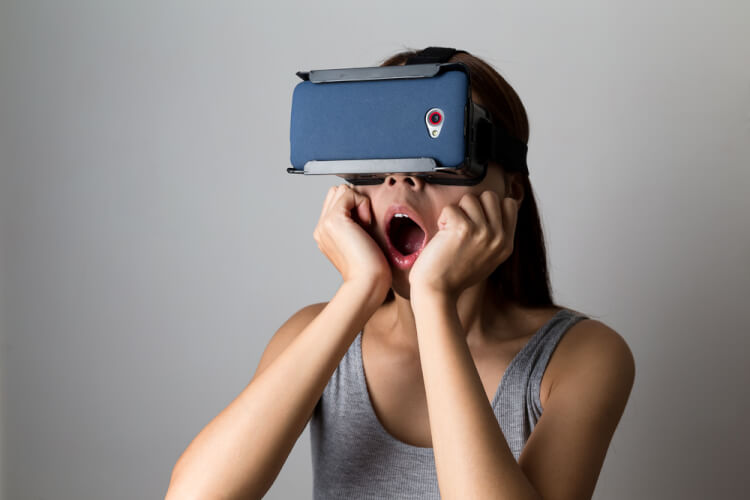 Young Woman feeling shocking for using the virtual reality device